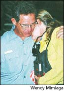 larry Wiese comforts Julie Bell, forced to leave her home